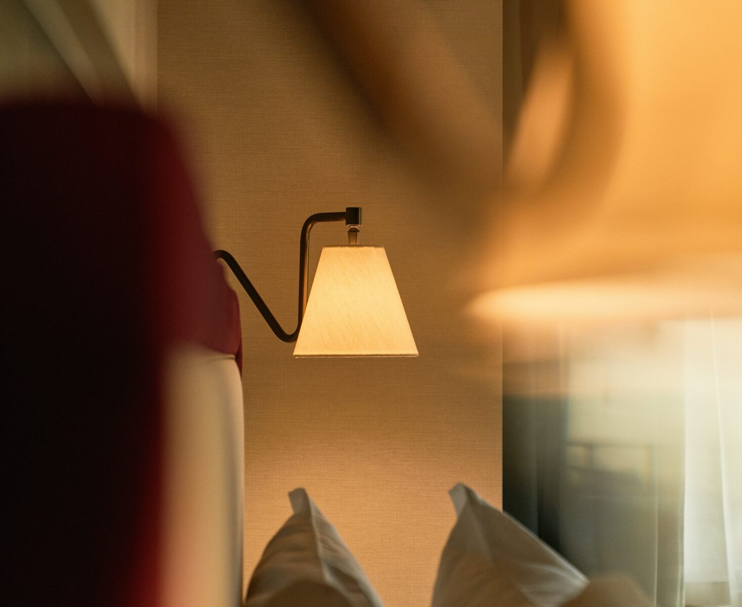 Dettaglio di lampada da parete accesa su fondo sfocato – Homy Livia Verona